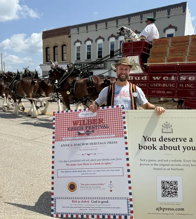 Daniel Dobesh standing behind Anne & Joachim Heritage Press display boards at the 2026 Wilber Czech Festival